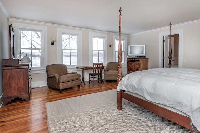 bedroom featuring wood-type flooring and crown molding