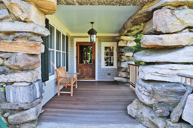 view of exterior entry featuring covered porch