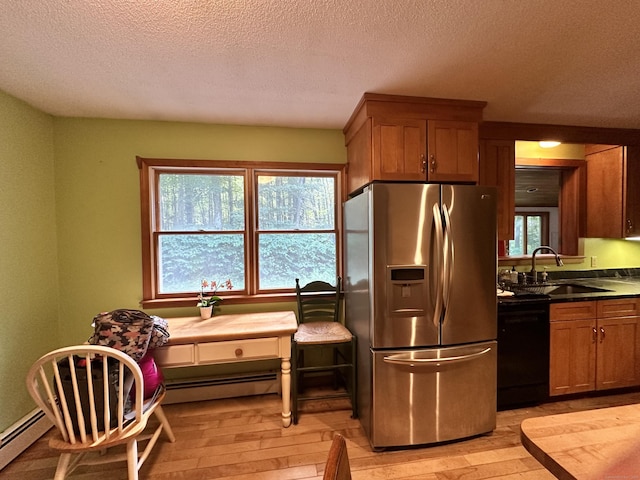 kitchen featuring black dishwasher, sink, light hardwood / wood-style floors, stainless steel refrigerator with ice dispenser, and a healthy amount of sunlight