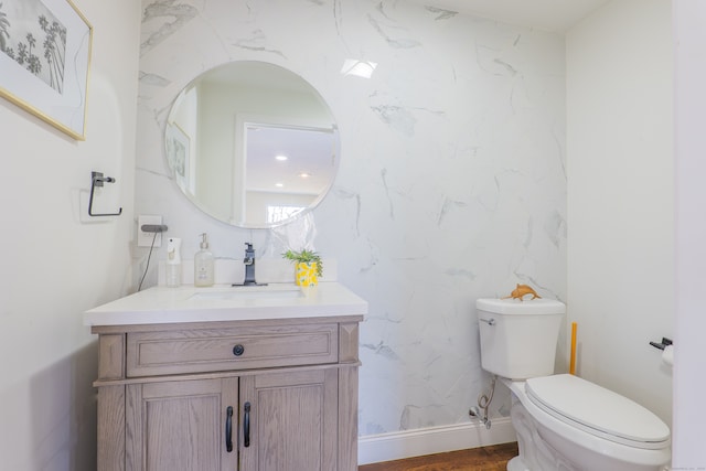 bathroom featuring vanity, toilet, and wood-type flooring