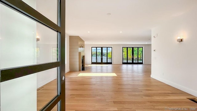 interior space with light wood-type flooring and french doors