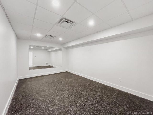 carpeted spare room with a paneled ceiling