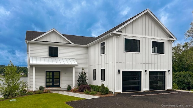 modern farmhouse style home featuring a front yard and a garage