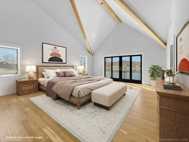 bedroom with access to outside, french doors, light wood-type flooring, and high vaulted ceiling