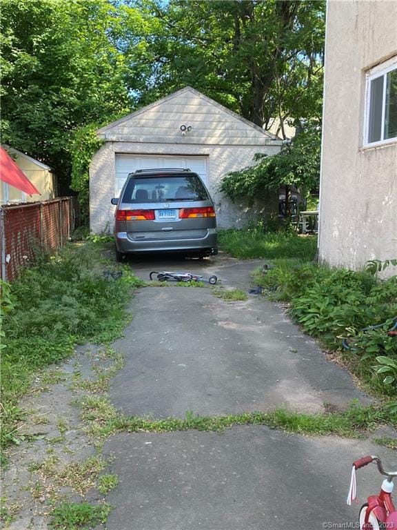 view of parking / parking lot with a garage