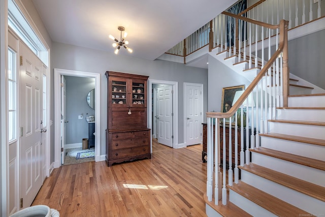 entryway with a notable chandelier and light hardwood / wood-style floors