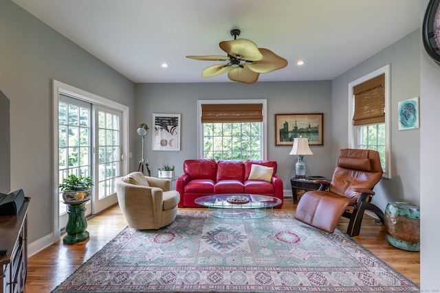 living room featuring hardwood / wood-style floors, plenty of natural light, and ceiling fan