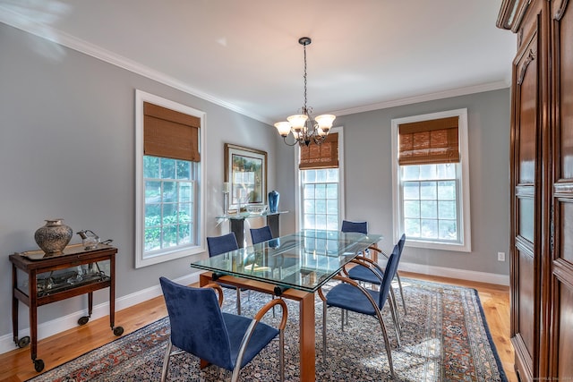 dining room featuring a chandelier, light hardwood / wood-style floors, and ornamental molding