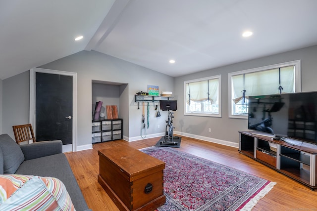 living room featuring light hardwood / wood-style floors and lofted ceiling