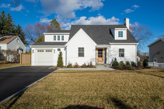 view of front of house featuring a front yard and a garage