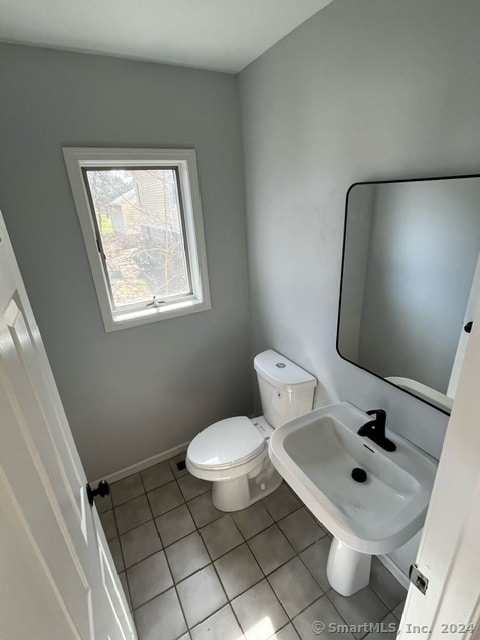 bathroom with sink, tile floors, and toilet