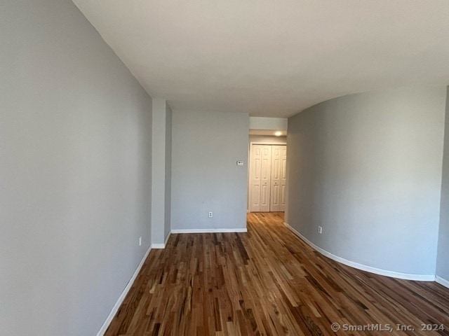 spare room featuring dark hardwood / wood-style flooring