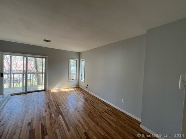 spare room with dark hardwood / wood-style floors