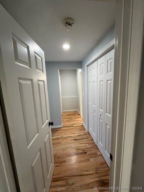 hall with light hardwood / wood-style flooring