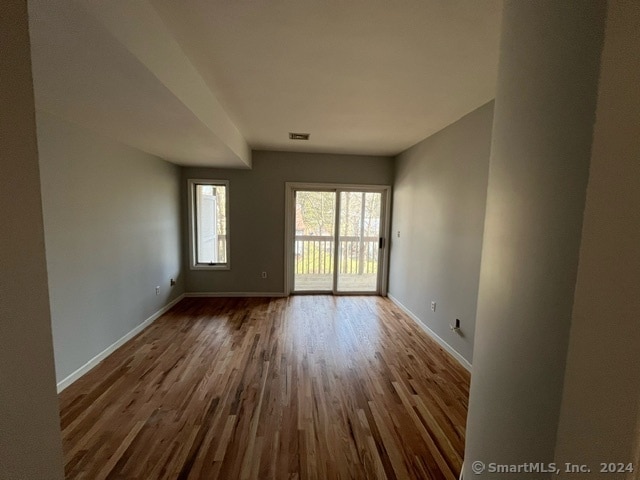 unfurnished room featuring dark hardwood / wood-style floors