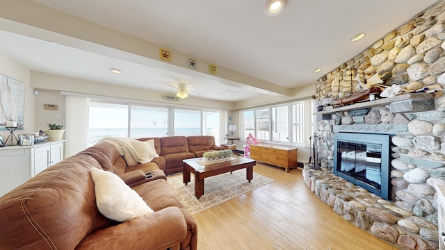 living area with a ceiling fan, recessed lighting, a fireplace, and light wood-type flooring