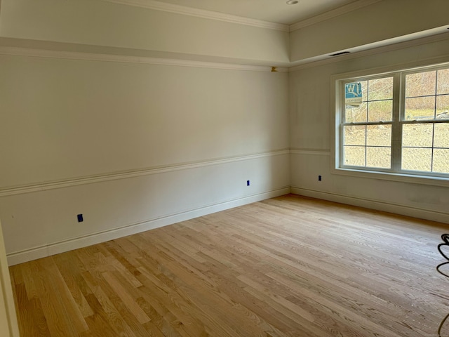 unfurnished room featuring light hardwood / wood-style floors and ornamental molding