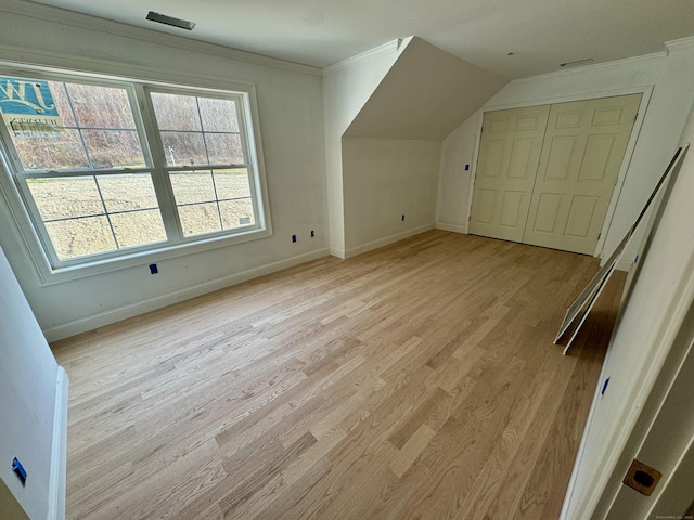 additional living space featuring light hardwood / wood-style floors and lofted ceiling