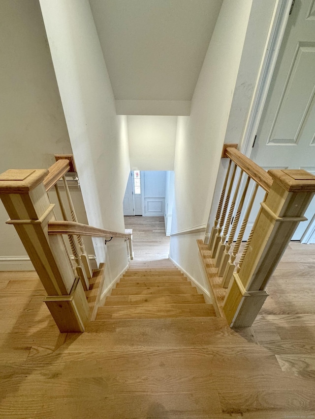 stairs with hardwood / wood-style floors