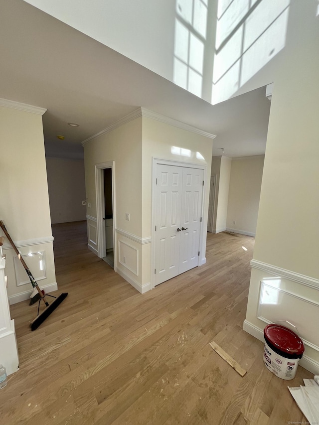 entryway featuring crown molding and light hardwood / wood-style flooring