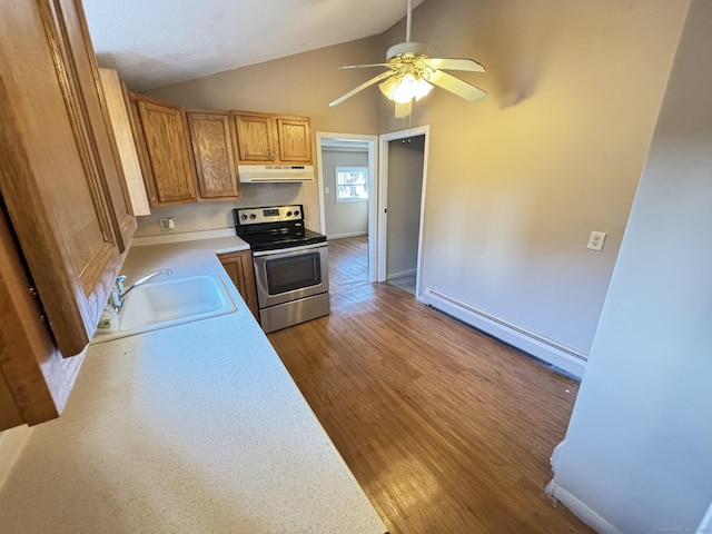 kitchen featuring lofted ceiling, sink, stainless steel range with electric cooktop, a baseboard heating unit, and light hardwood / wood-style floors