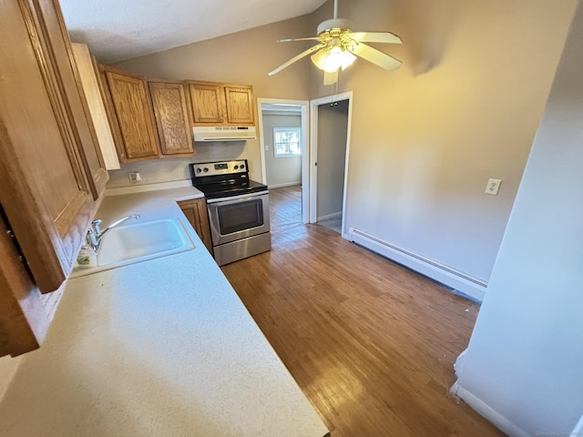 kitchen with sink, stainless steel electric range oven, vaulted ceiling, light wood-type flooring, and baseboard heating