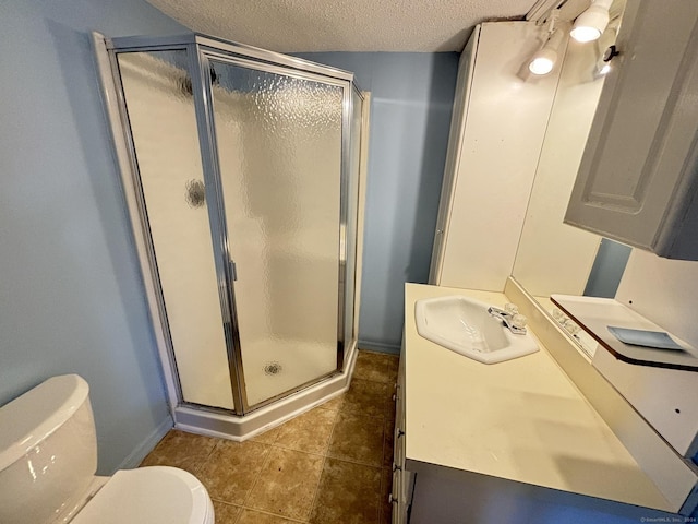 bathroom with toilet, an enclosed shower, a textured ceiling, vanity, and tile patterned flooring