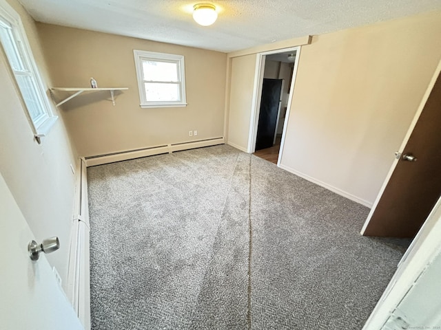 unfurnished bedroom with a baseboard radiator, carpet floors, and a textured ceiling