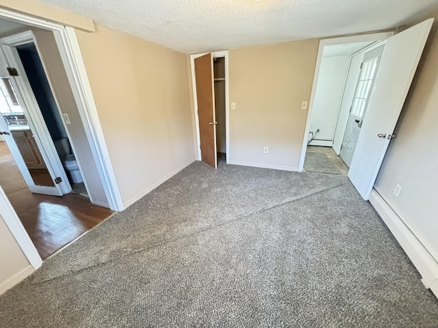 unfurnished bedroom featuring carpet flooring, a textured ceiling, and a closet