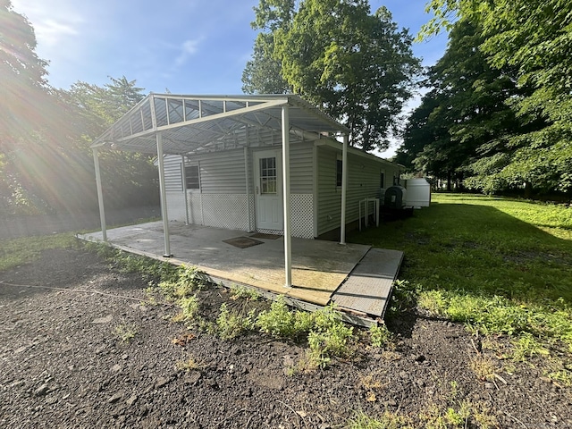 rear view of house featuring a lawn