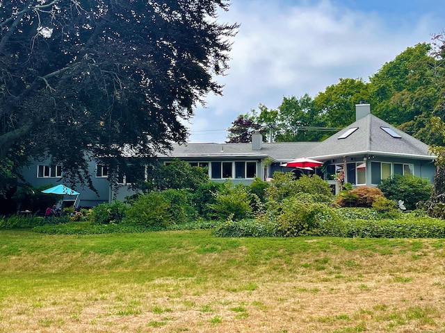 single story home featuring a chimney