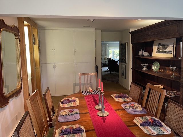 dining space featuring baseboards and wood finished floors