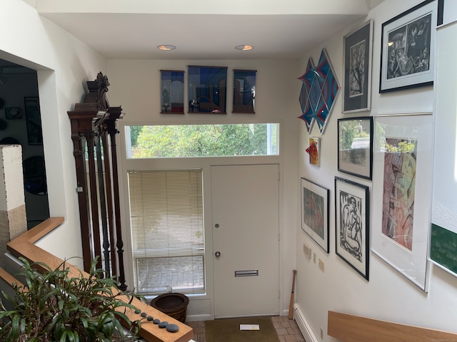 foyer entrance featuring baseboard heating