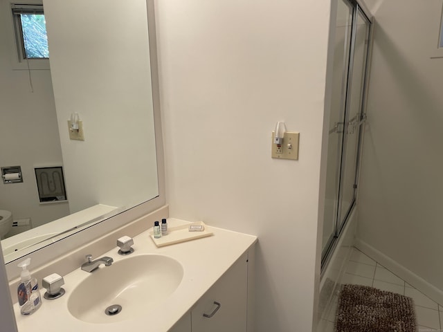 bathroom featuring tile patterned floors, a shower with shower door, vanity, and toilet