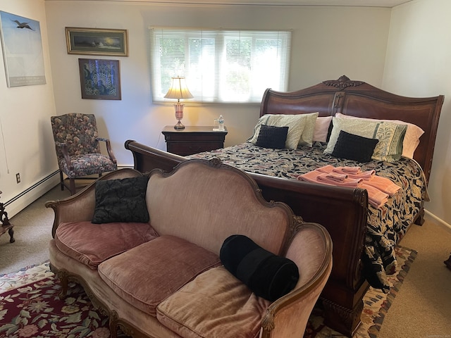carpeted bedroom with a baseboard heating unit and baseboards