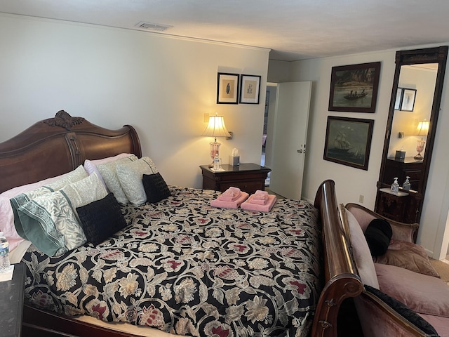 carpeted bedroom featuring visible vents