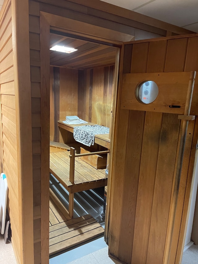 view of sauna / steam room featuring wooden walls