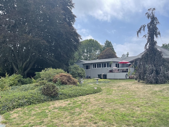 exterior space featuring a front yard and a deck
