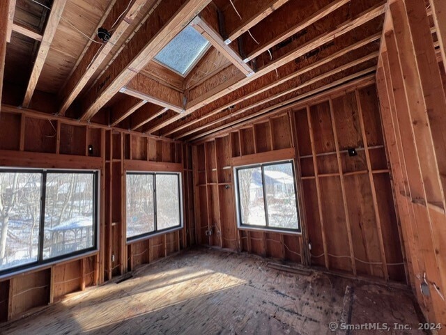 misc room with a skylight