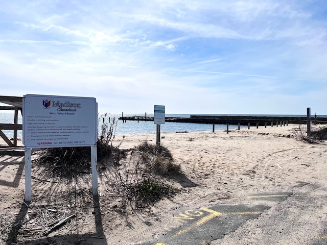 view of yard with a water view and a view of the beach