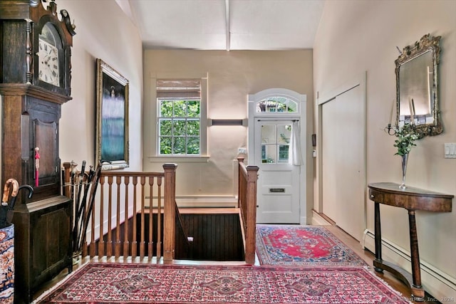 foyer with a baseboard radiator and hardwood / wood-style flooring