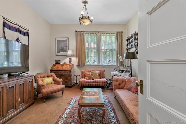 sitting room with an inviting chandelier and light carpet