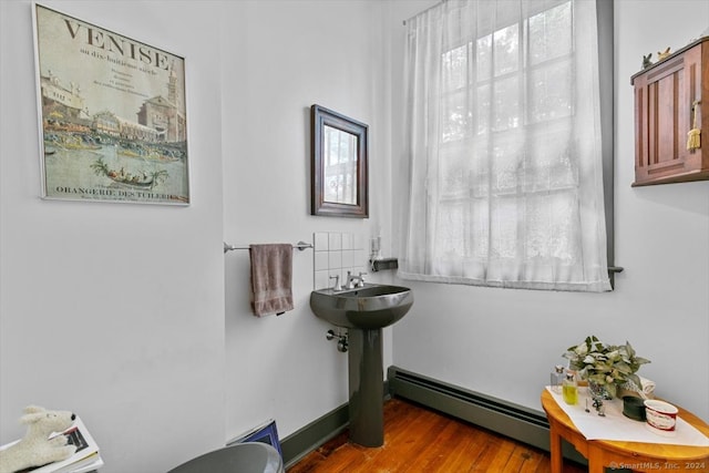 interior space with wood-type flooring and baseboard heating