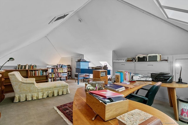 office with light colored carpet and lofted ceiling with skylight