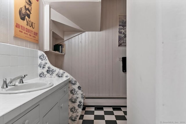 bathroom featuring vanity, tile flooring, and a baseboard heating unit