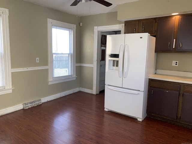 kitchen featuring ceiling fan, dark brown cabinets, white fridge with ice dispenser, and dark hardwood / wood-style floors