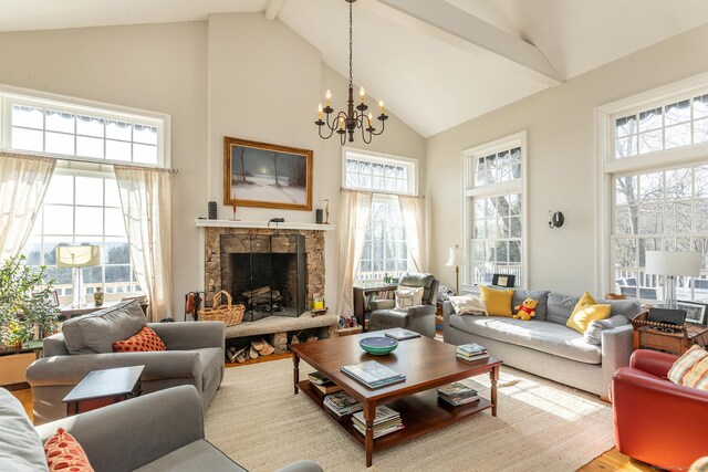 living room featuring light wood-type flooring, a chandelier, beamed ceiling, high vaulted ceiling, and a stone fireplace