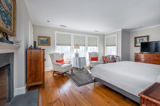 bedroom with ornamental molding and hardwood / wood-style floors