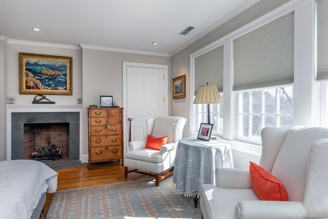 bedroom with crown molding and hardwood / wood-style floors