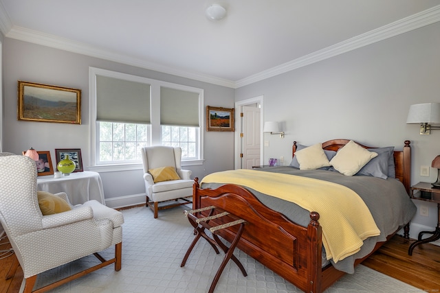 bedroom with light hardwood / wood-style flooring and crown molding